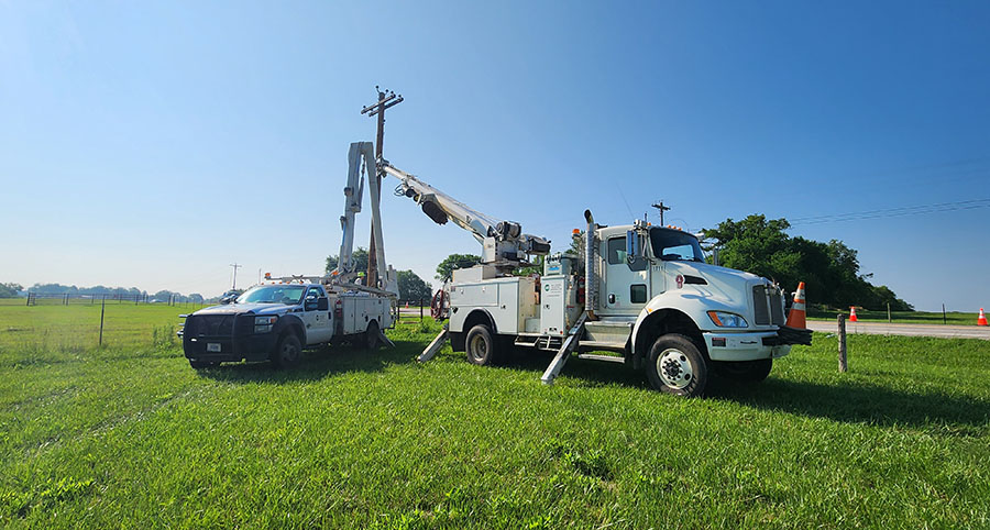 Lift trucks in a open rural farm field.