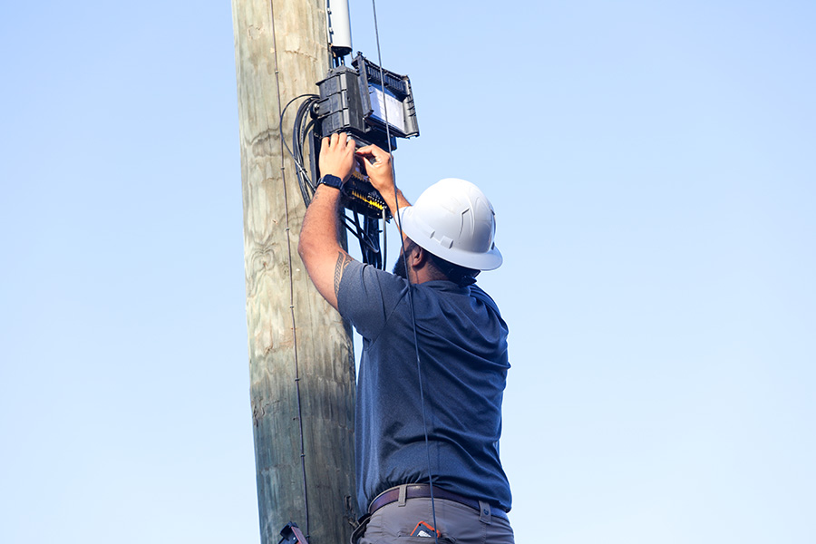 Service industry worker working on power pole.