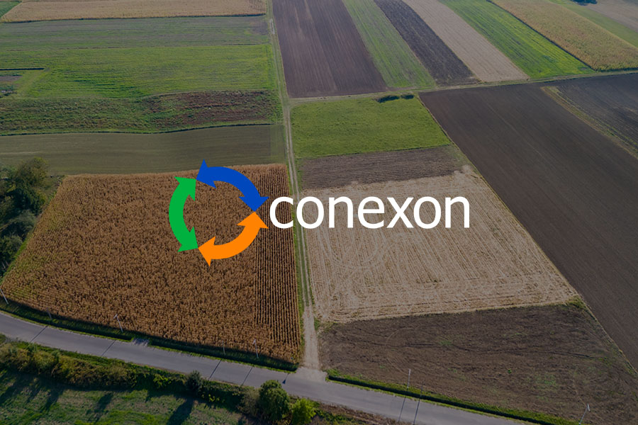 An arial view of a farmers field with different crops and a Conexon logo.