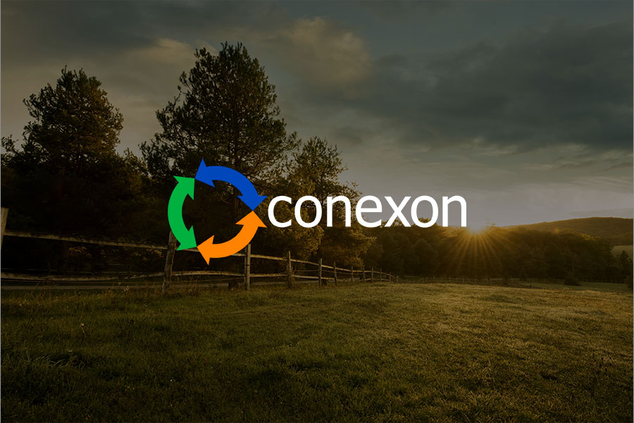 A rural American field with a old wooden fence at sunrise with a Conexon logo.